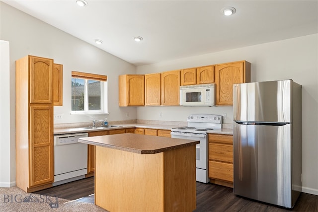 kitchen with a center island, vaulted ceiling, white appliances, sink, and dark hardwood / wood-style floors