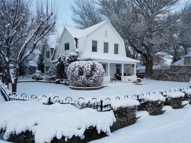 exterior space with a gambrel roof and covered porch