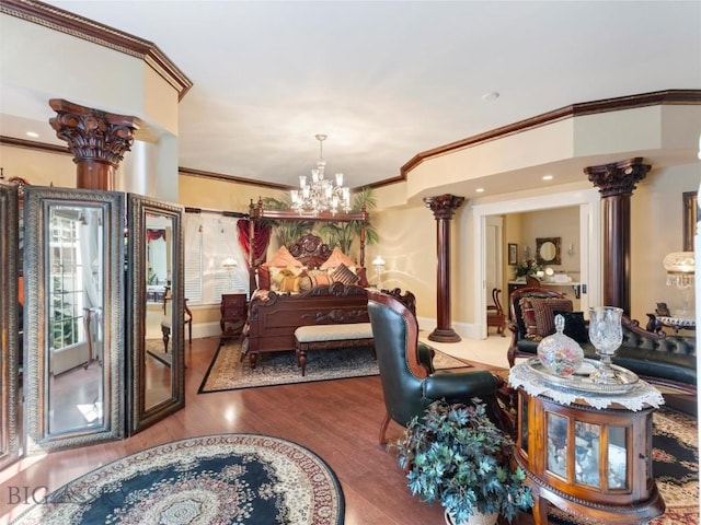 interior space featuring an inviting chandelier, wood finished floors, crown molding, and decorative columns