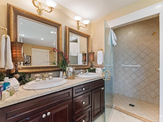bathroom featuring tile patterned flooring, a sink, a shower stall, and double vanity