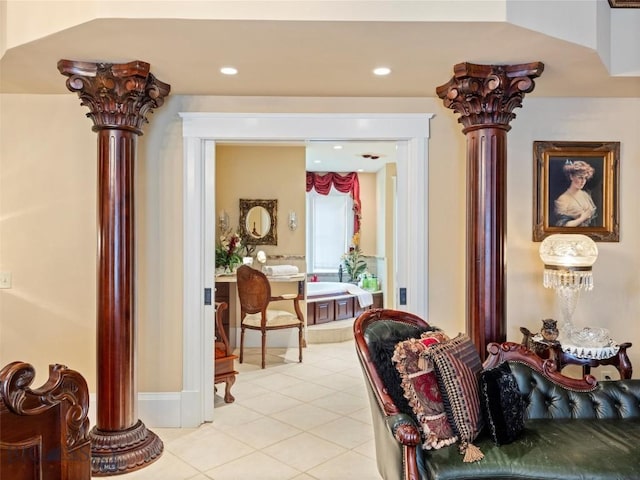 interior space featuring light tile patterned floors, recessed lighting, and decorative columns