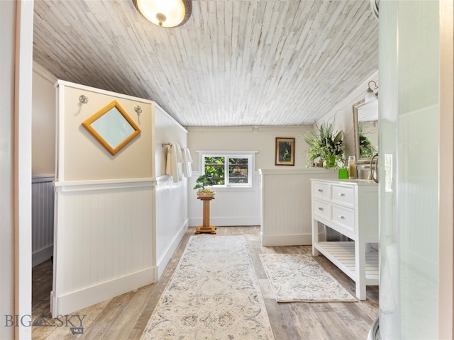 interior space with ornamental molding, wooden ceiling, and hardwood / wood-style flooring