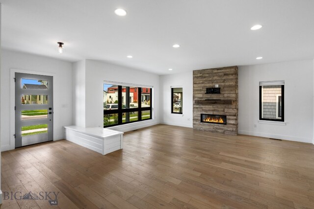 unfurnished living room featuring a fireplace and wood-type flooring