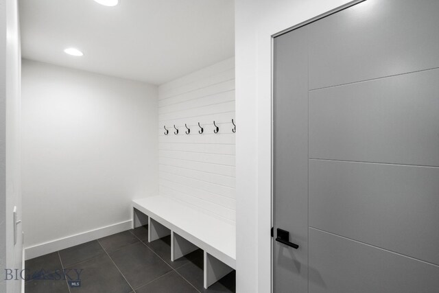 mudroom featuring dark tile patterned floors