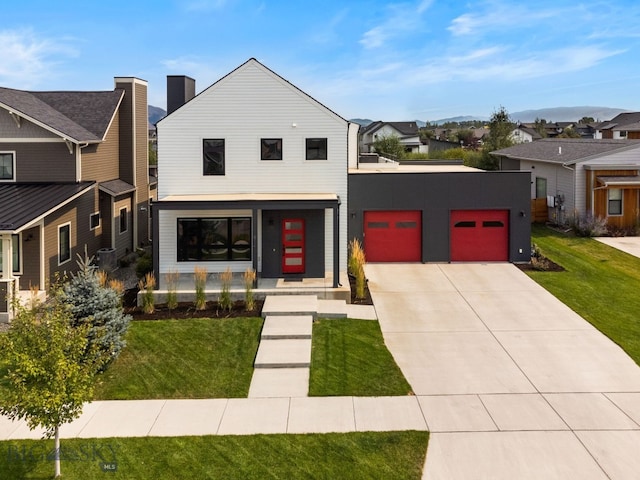 view of front of house with a garage and a front lawn