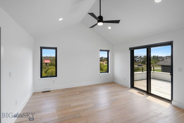 spare room featuring high vaulted ceiling, ceiling fan, and light hardwood / wood-style floors