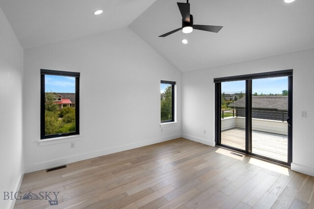 unfurnished room with ceiling fan, light hardwood / wood-style flooring, vaulted ceiling, and a wealth of natural light