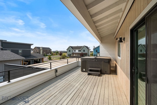 wooden deck with a hot tub