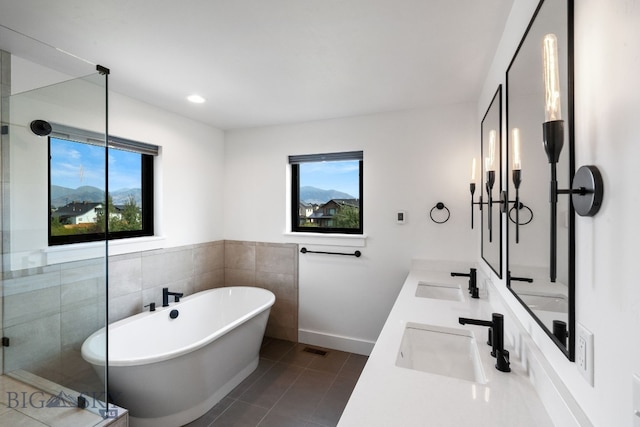 bathroom with a mountain view, vanity, tile patterned floors, and shower with separate bathtub