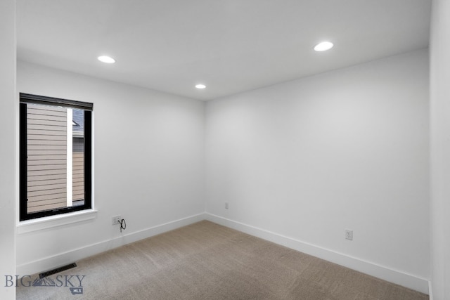 empty room featuring light carpet