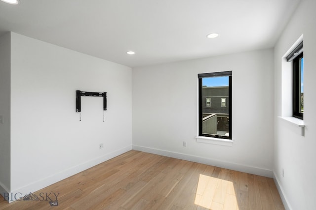 spare room featuring light wood-type flooring