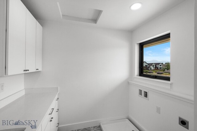 laundry room with cabinets, hookup for an electric dryer, and washer hookup