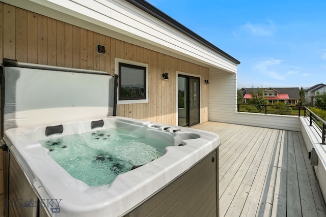 wooden terrace with a hot tub