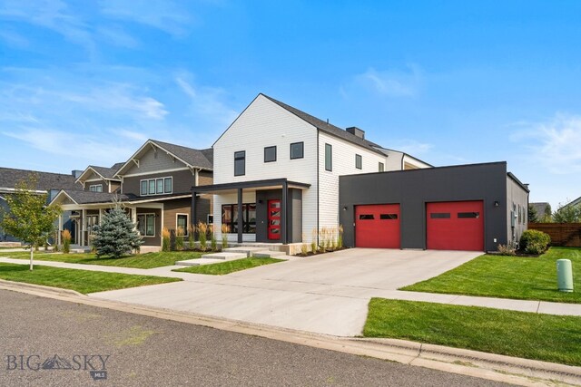 view of front of home with a front lawn and a garage