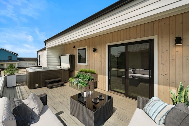 wooden deck featuring a hot tub