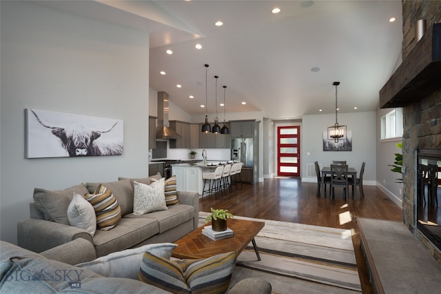 living room featuring dark hardwood / wood-style flooring, a wealth of natural light, and high vaulted ceiling