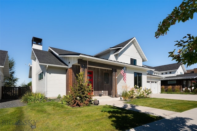 view of front of property featuring a garage and a front yard