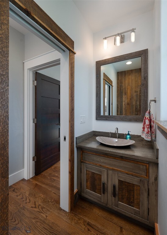 bathroom with vanity and hardwood / wood-style flooring