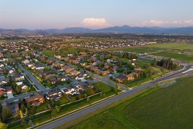 aerial view at dusk featuring a mountain view