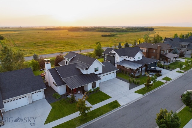 aerial view at dusk featuring a rural view