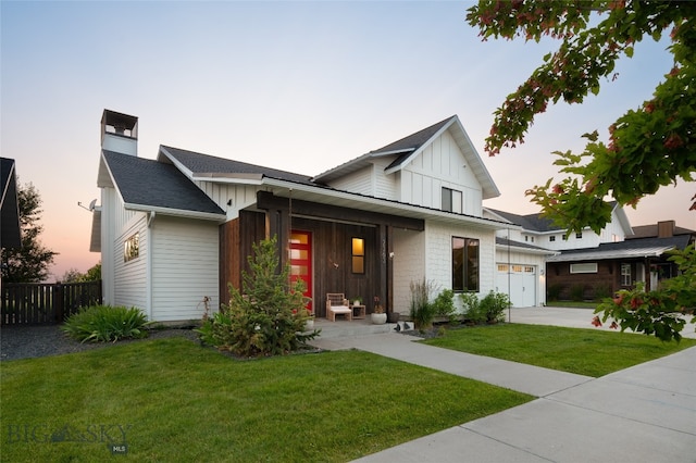 view of front facade featuring a garage and a lawn