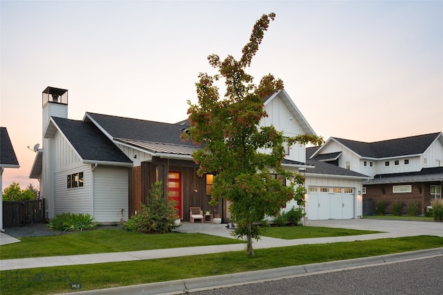 view of front of home with a lawn and a garage