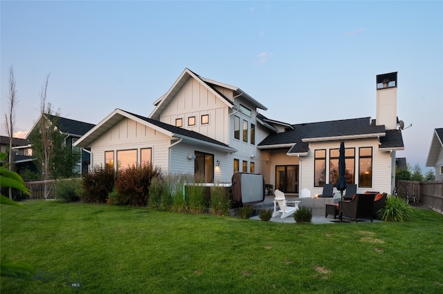 rear view of house with an outdoor living space, a yard, and a patio