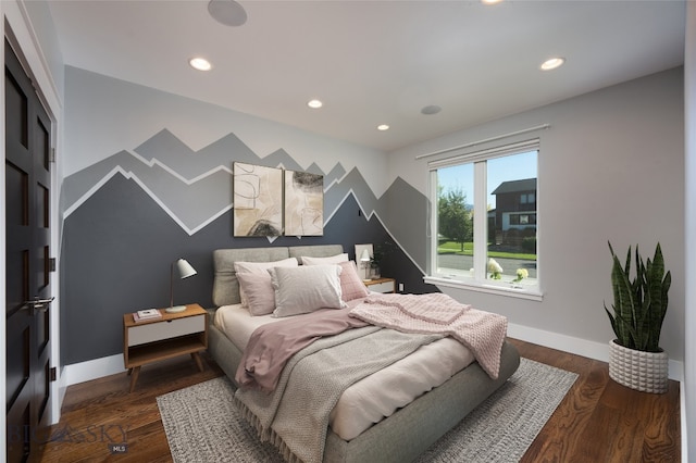 bedroom with dark hardwood / wood-style floors