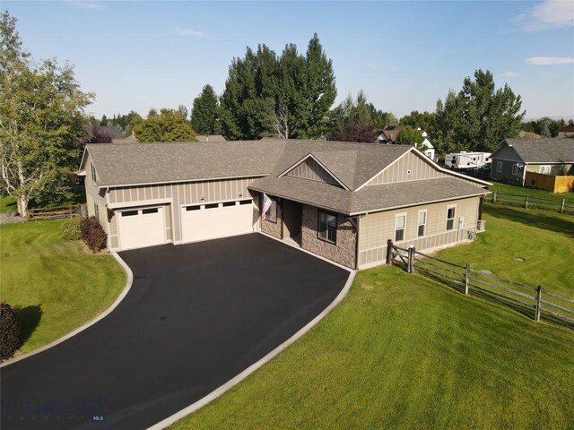 view of front of home with a front yard and a garage