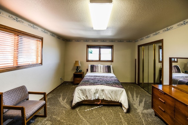 carpeted bedroom featuring a textured ceiling and a closet