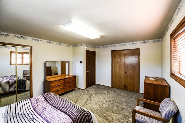 carpeted bedroom featuring a textured ceiling