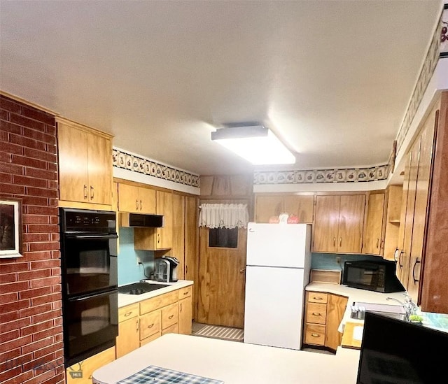 805 E Orr St, Dillon, MT 59725 - kitchen featuring light countertops, a peninsula, under cabinet range hood, and black appliances
