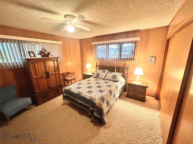 bedroom with a closet, a textured ceiling, ceiling fan, and carpet flooring