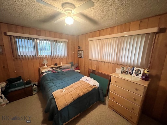 805 E Orr St, Dillon, MT 59725 - carpeted bedroom with a textured ceiling, a ceiling fan, and wooden walls