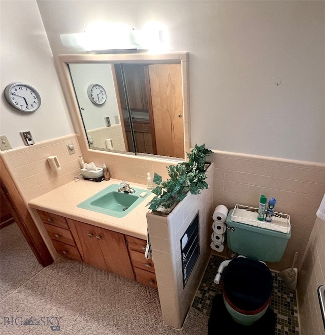 bathroom with vanity, toilet, tile walls, and tasteful backsplash