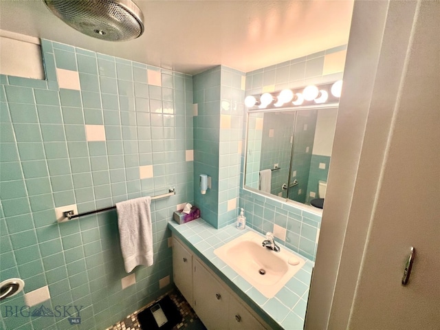 bathroom with tile walls, decorative backsplash, and vanity