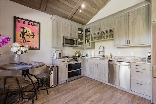 kitchen featuring appliances with stainless steel finishes, lofted ceiling with beams, sink, wood ceiling, and light hardwood / wood-style floors