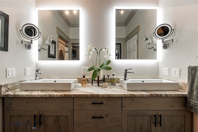 bathroom featuring crown molding and vanity