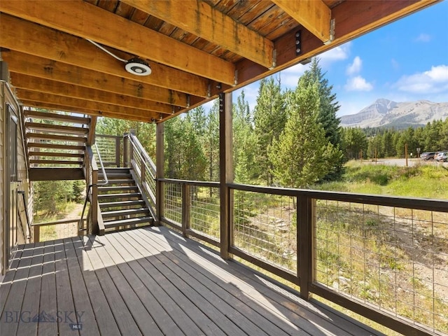 wooden terrace featuring a mountain view and stairs