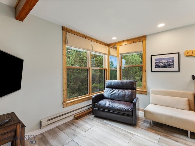 living area with a baseboard heating unit, a wealth of natural light, wood tiled floor, and recessed lighting