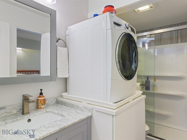 washroom featuring sink and washer / clothes dryer