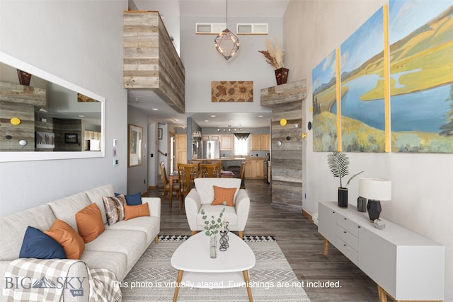 living room featuring dark wood-type flooring and a high ceiling