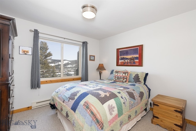 carpeted bedroom featuring a baseboard heating unit