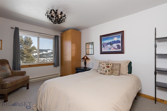 carpeted bedroom featuring a baseboard heating unit