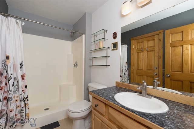 bathroom featuring walk in shower, toilet, and vanity