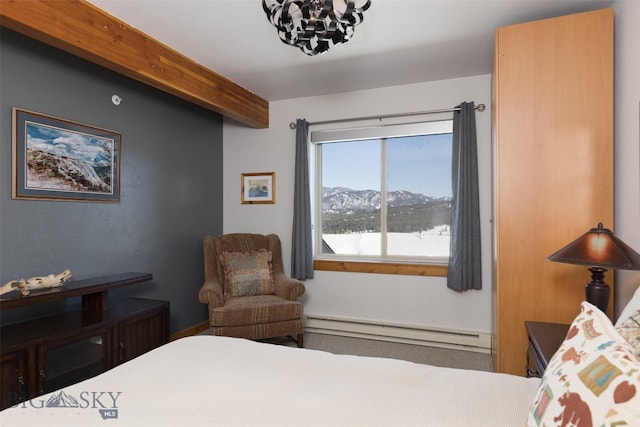 carpeted bedroom featuring a baseboard heating unit, a mountain view, and beam ceiling