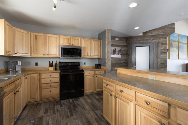 kitchen featuring light brown cabinets, stainless steel appliances, dark hardwood / wood-style flooring, and wooden walls