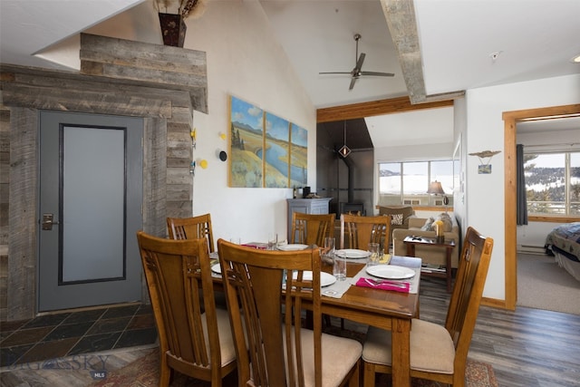 dining space featuring dark wood-type flooring, ceiling fan, and lofted ceiling with beams