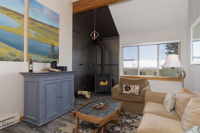 living room featuring a wood stove, a baseboard radiator, beamed ceiling, and hardwood / wood-style flooring