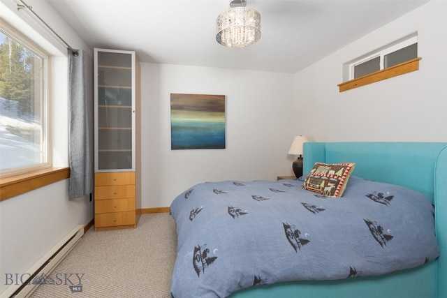 carpeted bedroom featuring baseboard heating and an inviting chandelier